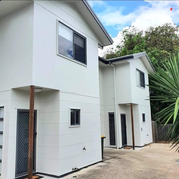A pair of white rendered units with charcoal window frames
